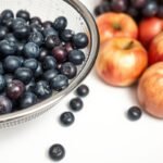 Fresh berries, grapes, and apples on a kitchen counter showing the difference between dry and washed produce