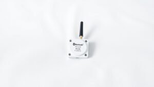 A small electronic monitoring device for gut health attached to white fabric.