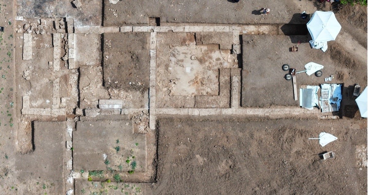 Ruins of the ancient school complex in Mieza, Greece, featuring stone columns and mosaic floors