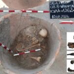 Archaeological excavation showing a Roman skeleton inside a large ceramic storage jar in Bulgaria.