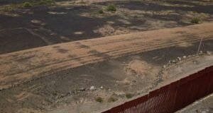 Aerial view of the Las Playas Intaglio fish carving in the Arizona desert with visible damage from machinery