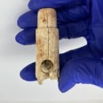 A 2,800-year-old bone flute fragment and a 4,500-year-old humanoid idol head discovered in ancient Troy