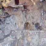 Archaeological excavation of a Roman-era house carved into schist bedrock on the coast of Corsica